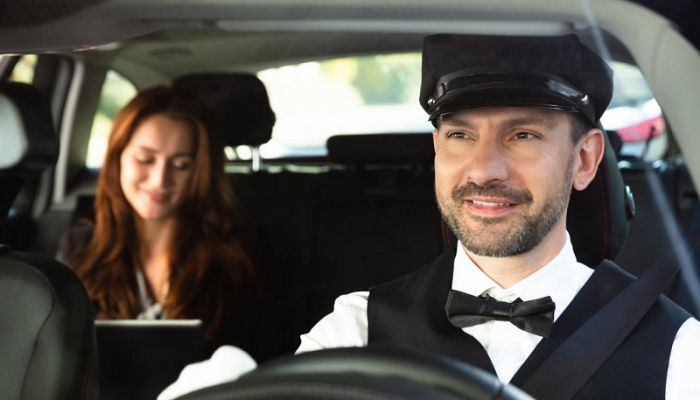 happy-male-chauffeur-driving-car happy-male-chauffeur-driving-car
